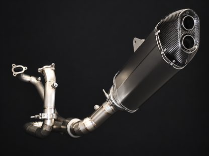 A high-performance exhaust system with a carbon fiber muffler and polished stainless steel pipes, shown against a solid black background.
