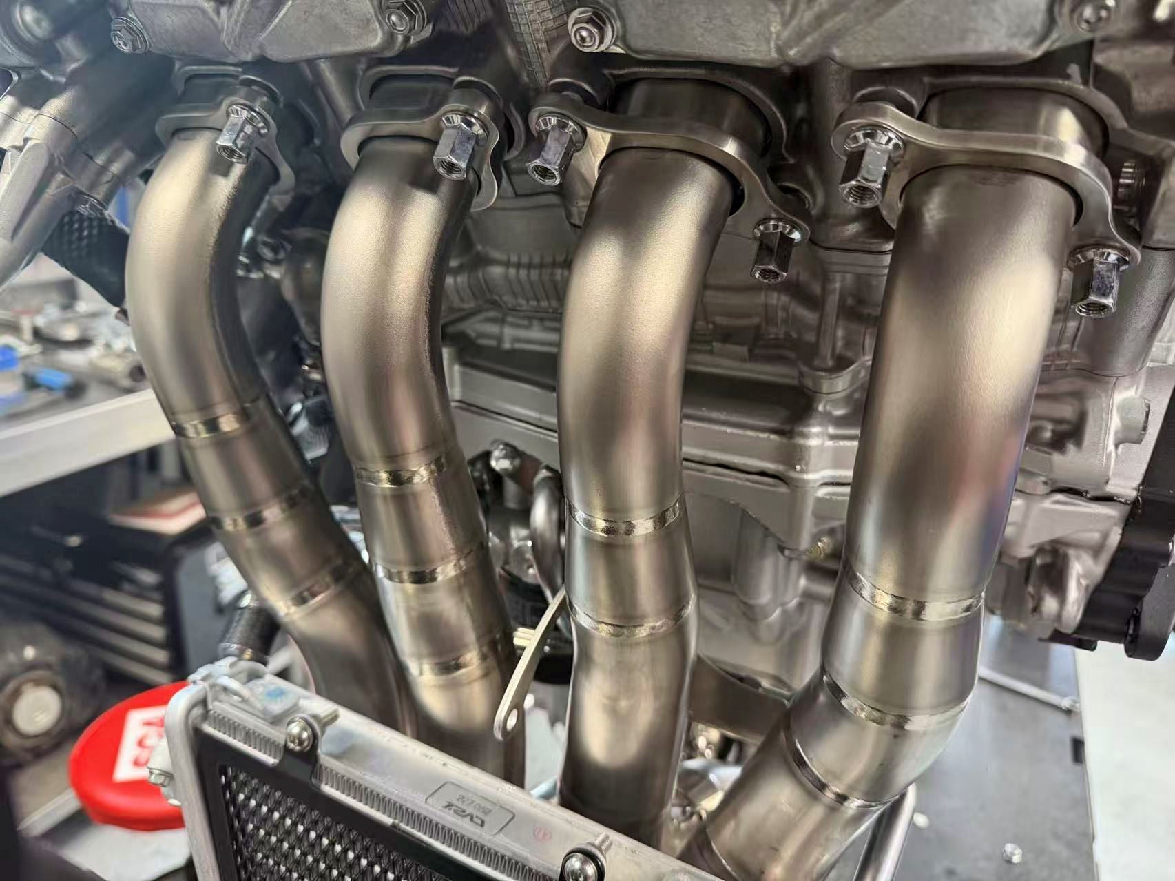 Close-up of a car engine with metallic pipes and components.