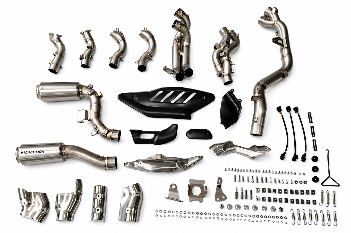 A complete motorcycle exhaust system kit with various stainless steel pipes, a muffler, black plastic guards.