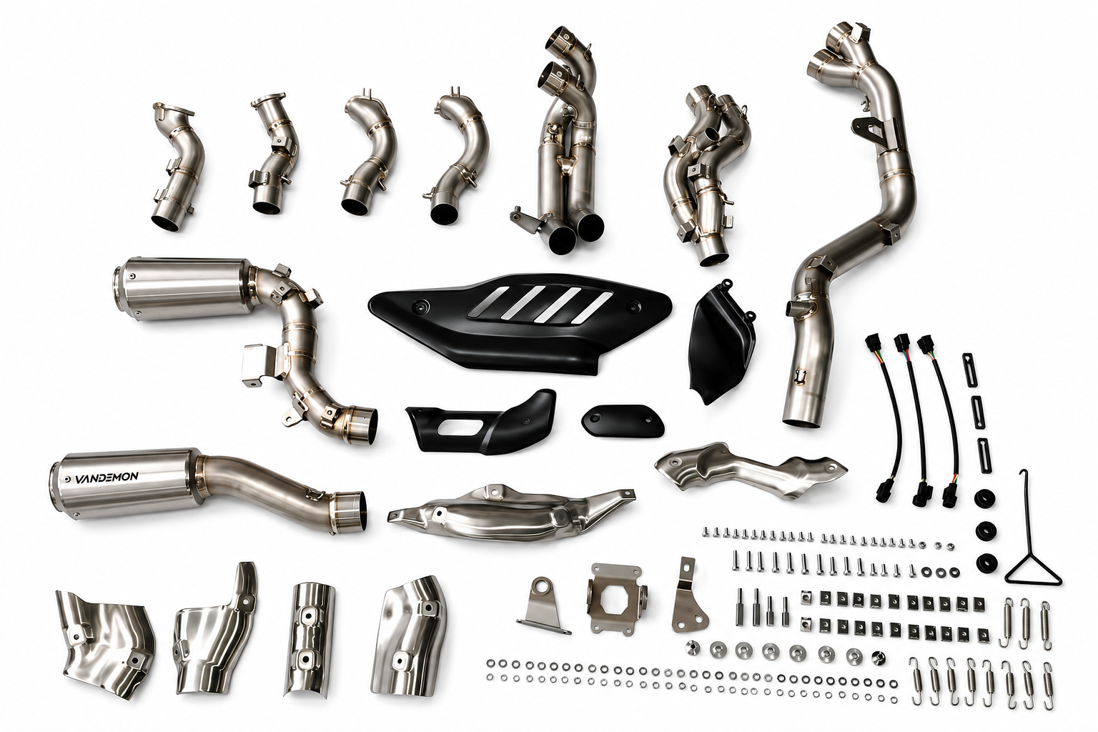 A complete motorcycle exhaust system kit with various stainless steel pipes, a muffler, black plastic guards.