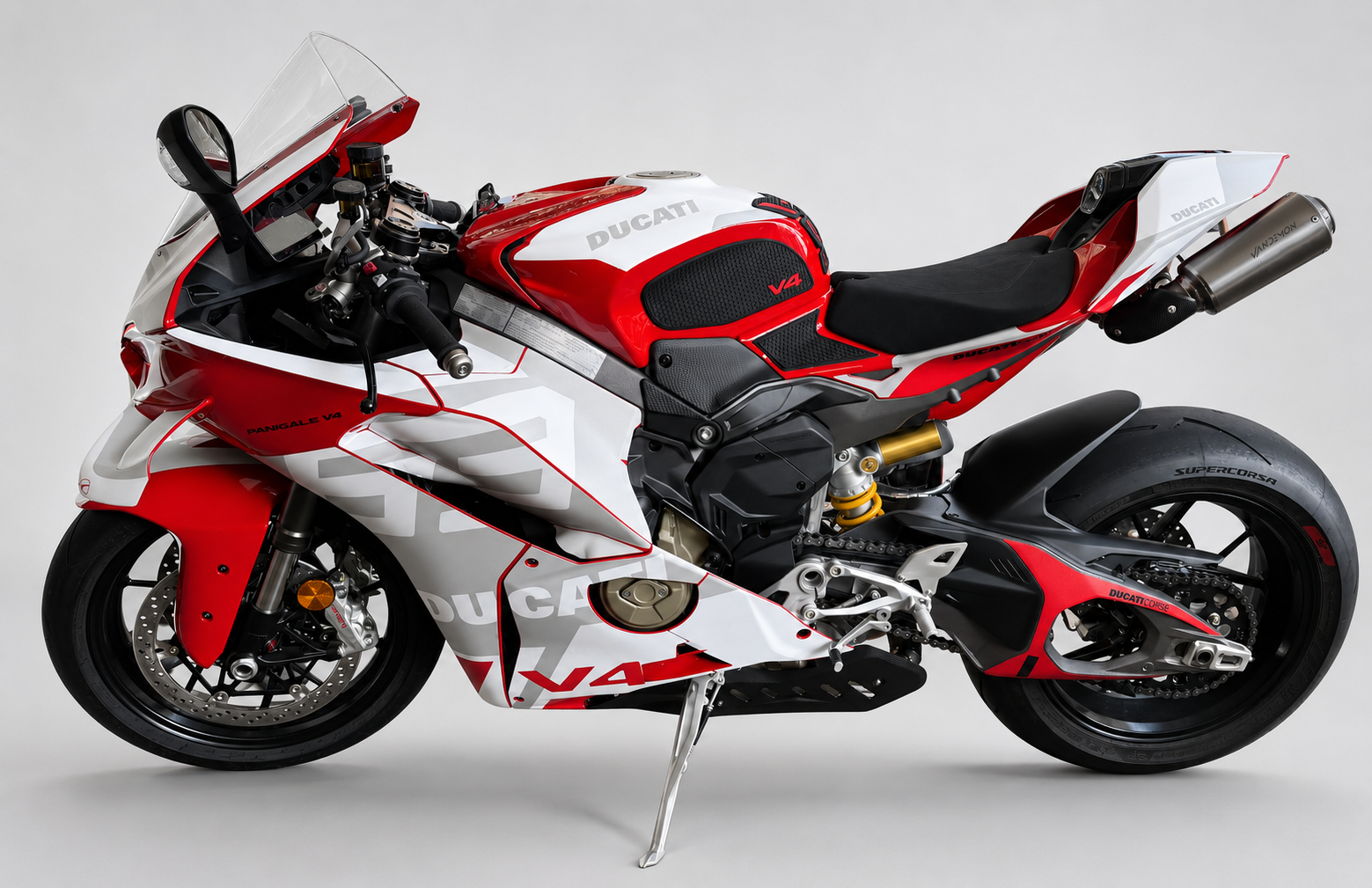 A Ducati V4R sport motorcycle in a red, white, and black livery, photographed from a side profile against a neutral light grey studio background.