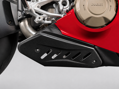 Close-up of a black carbon-fiber-textured motorcycle side cover mounted over a red Ducati engine casing.