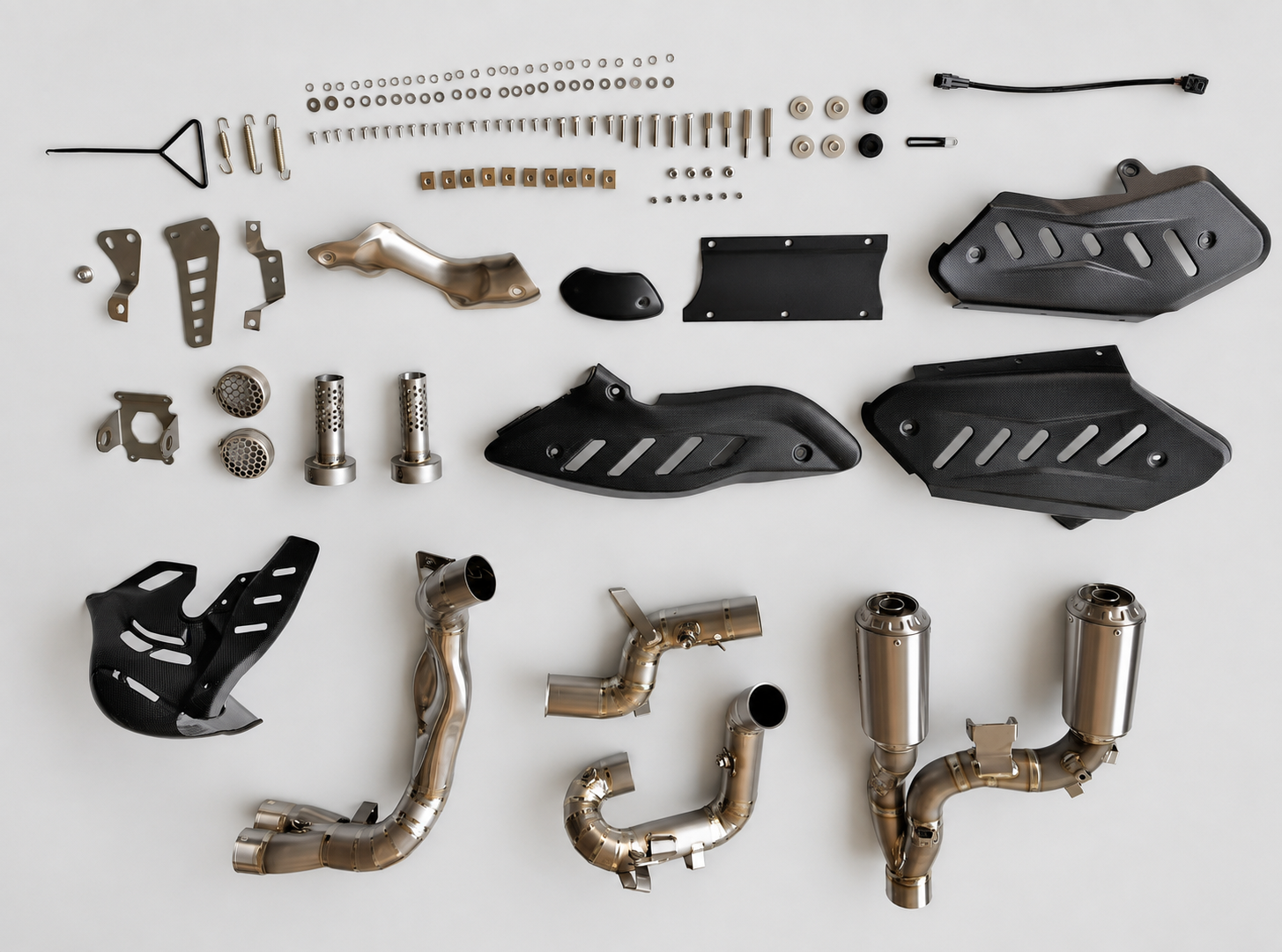 A complete motorcycle exhaust and muffler kit laid out on a clean white background, including stainless steel pipes, dual exhaust tips, black plastic guards, mounting hardware, and tools.