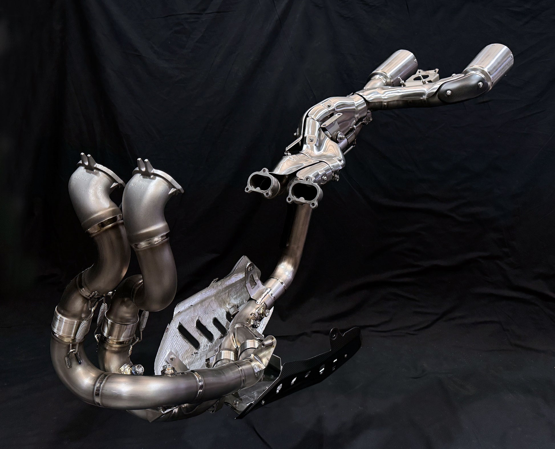 Metallic exhaust system on a black background