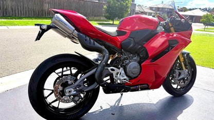 Red motorcycle parked on a driveway with a residential background