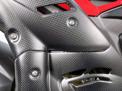 Close-up of a carbon fibre motorcycle part 2025 Panigale V4 carbon with red accents