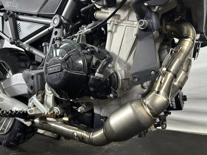 Close-up of a motorcycle engine with a visible brand logo on a white background