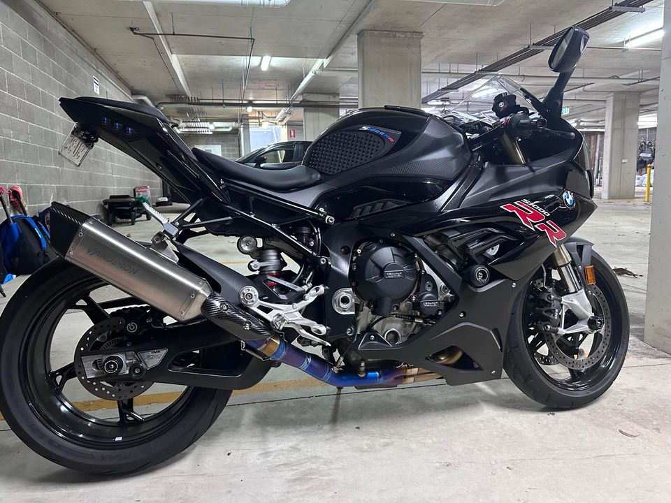 Black motorcycle with visible branding in a parking garage.