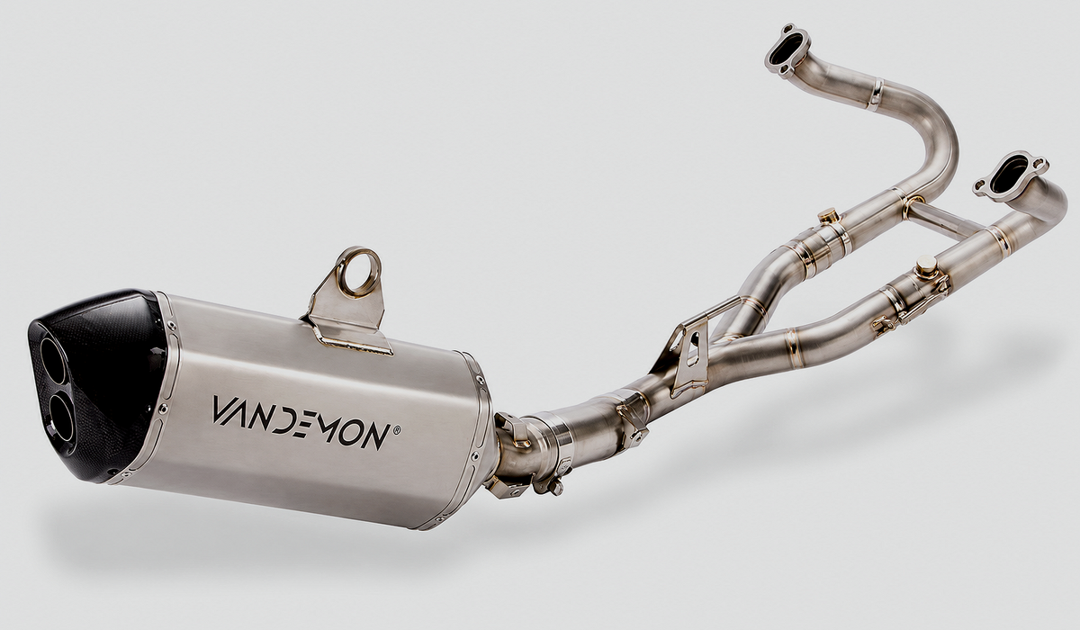 A Vandemon stainless steel exhaust system with a cylindrical muffler and dual header pipes, shown on a light grey background.