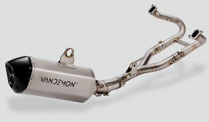 A Vandemon stainless steel exhaust system with a cylindrical muffler and dual header pipes, shown on a light grey background.