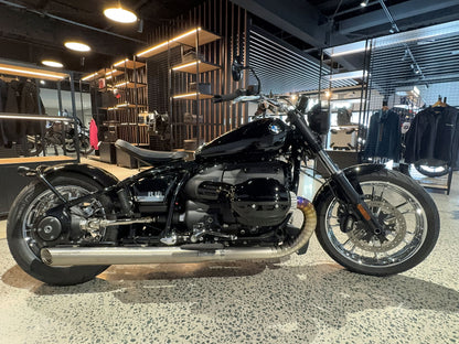 A motorcycle stands parked in a retail store, surrounded by various products on display.