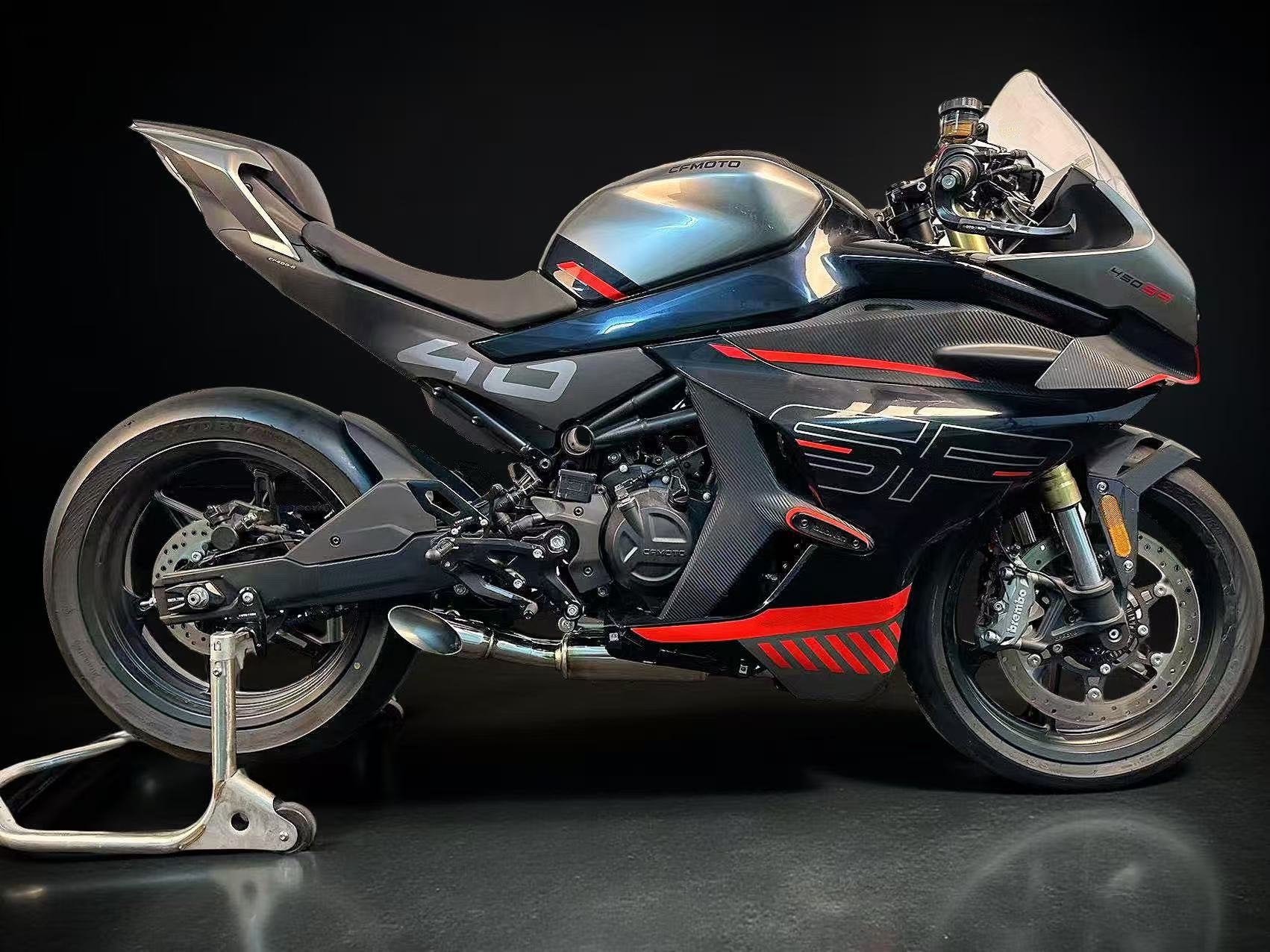 Black and red CFMOTO motorcycle with low mount Stainless Steel Exhaust