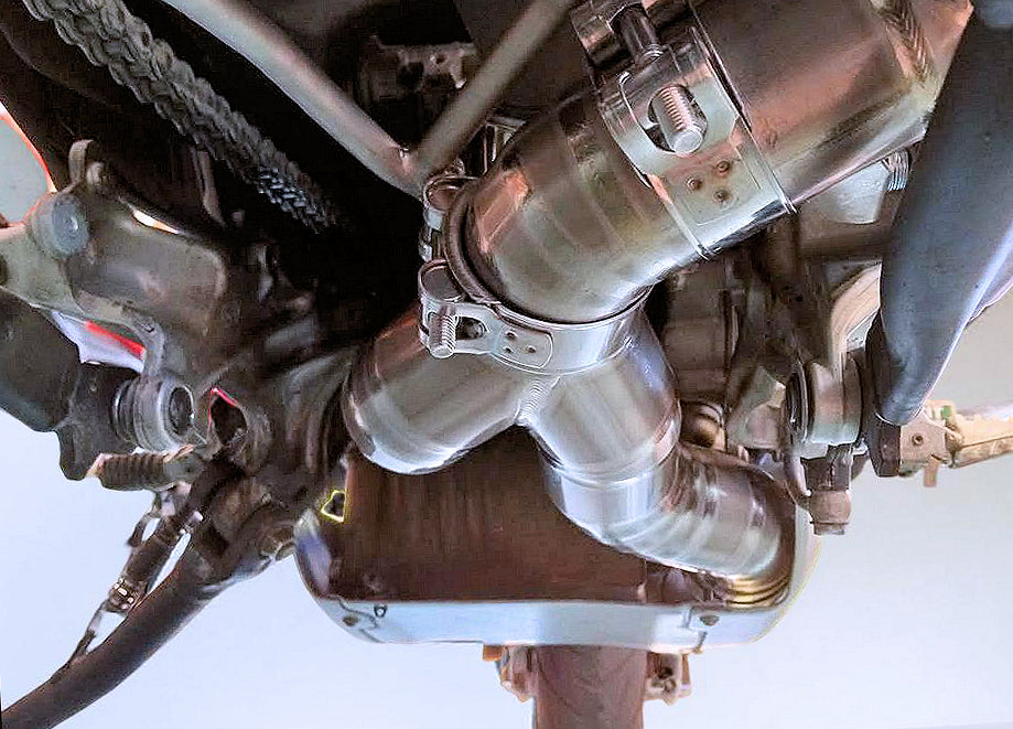 Close-up of a motorcycle exhaust system on a white background