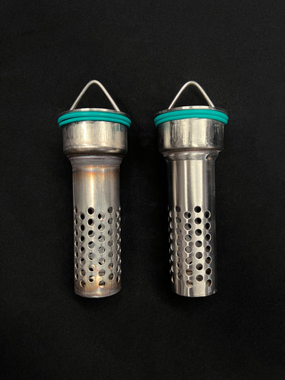Two metallic cylindrical objects with perforated designs on a black background