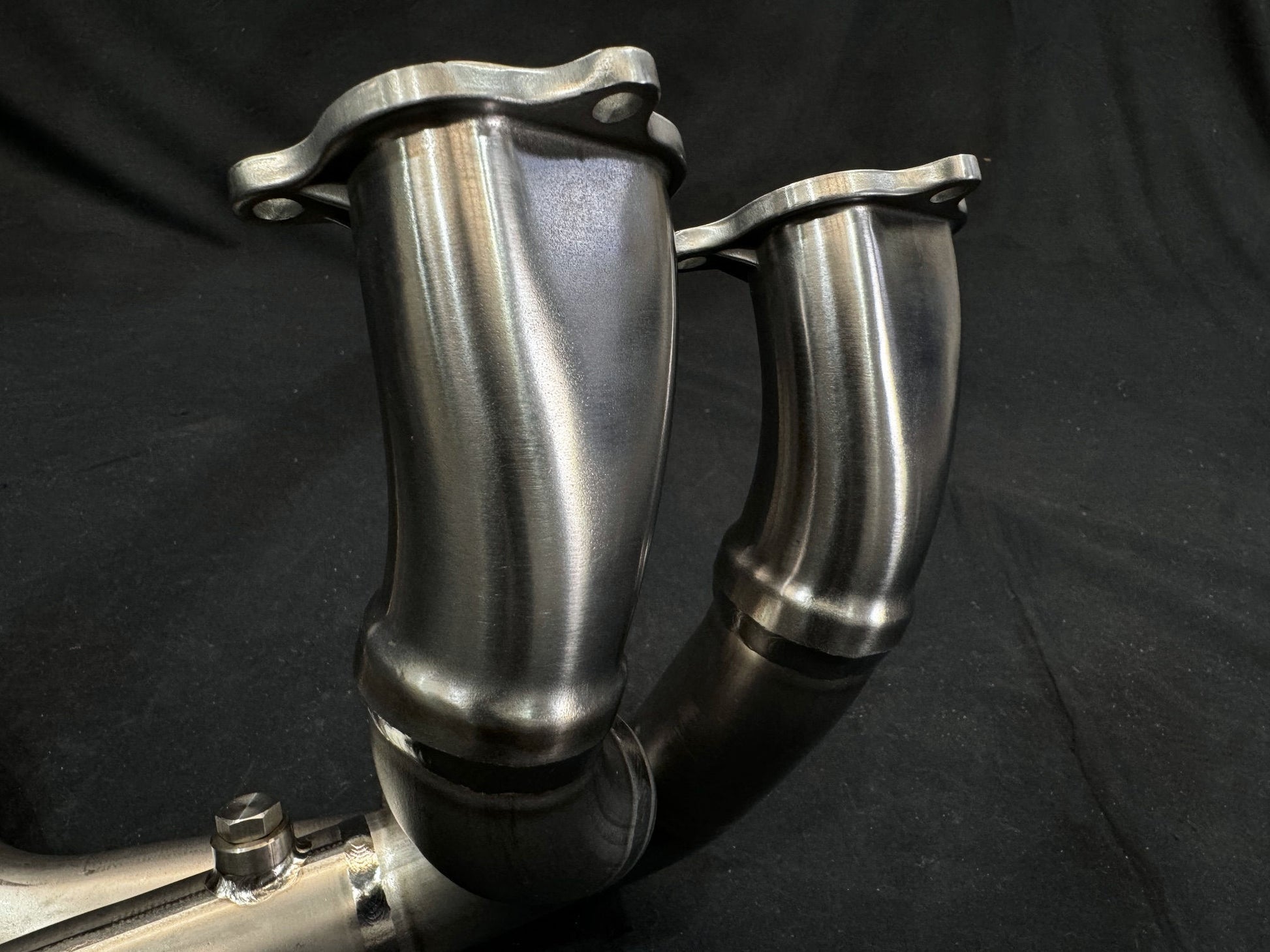 Metallic exhaust pipe on a black background