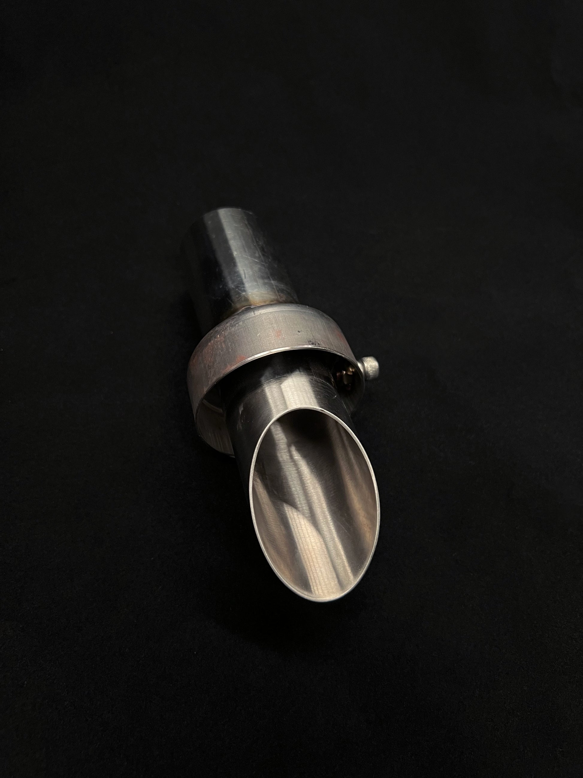 Metal exhaust bit on a black background