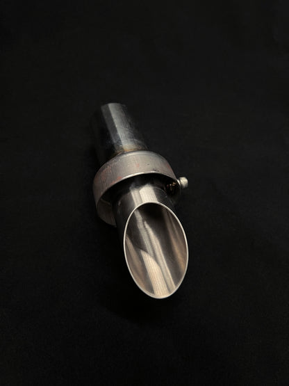 Metal exhaust bit on a black background