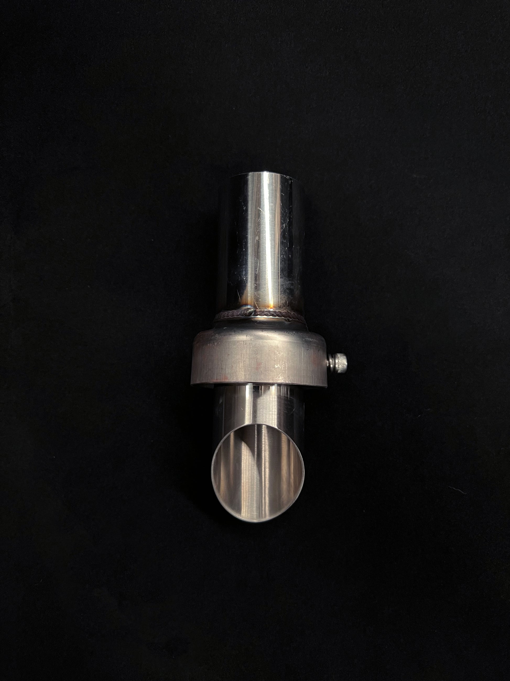 Metallic cylindrical object on a black background