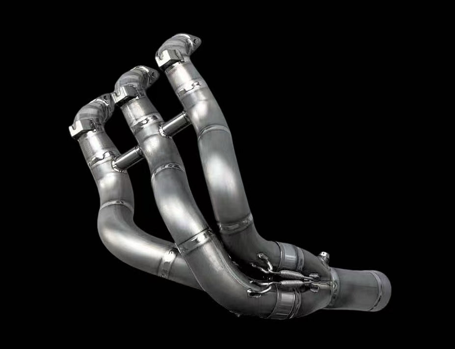 Metallic exhaust manifold on a black background