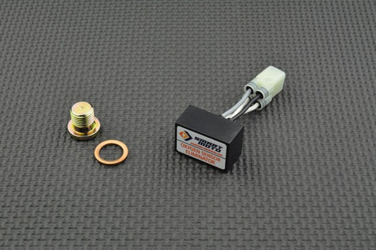Mechanical components, including a bolt, washer, and electronic module, on a textured grey surface.
