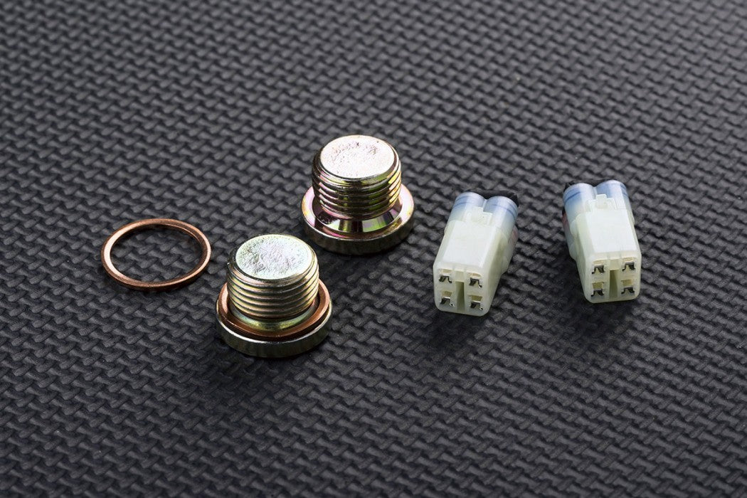 Set of metal bolts and connectors on a textured grey surface