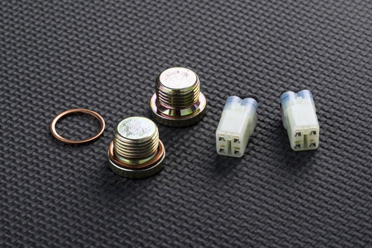 Set of metal bolts and connectors on a textured grey surface