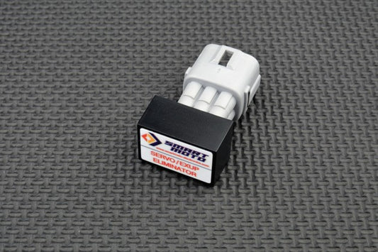 Small mechanical component with a brand label on a textured grey background