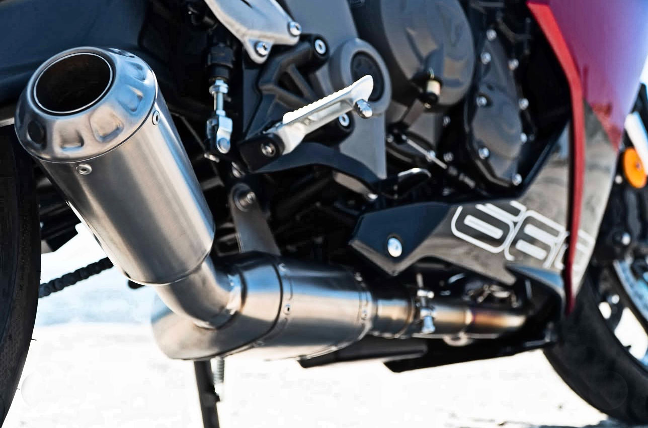 Close-up of metallic exhaust motorcycle, intricate details.