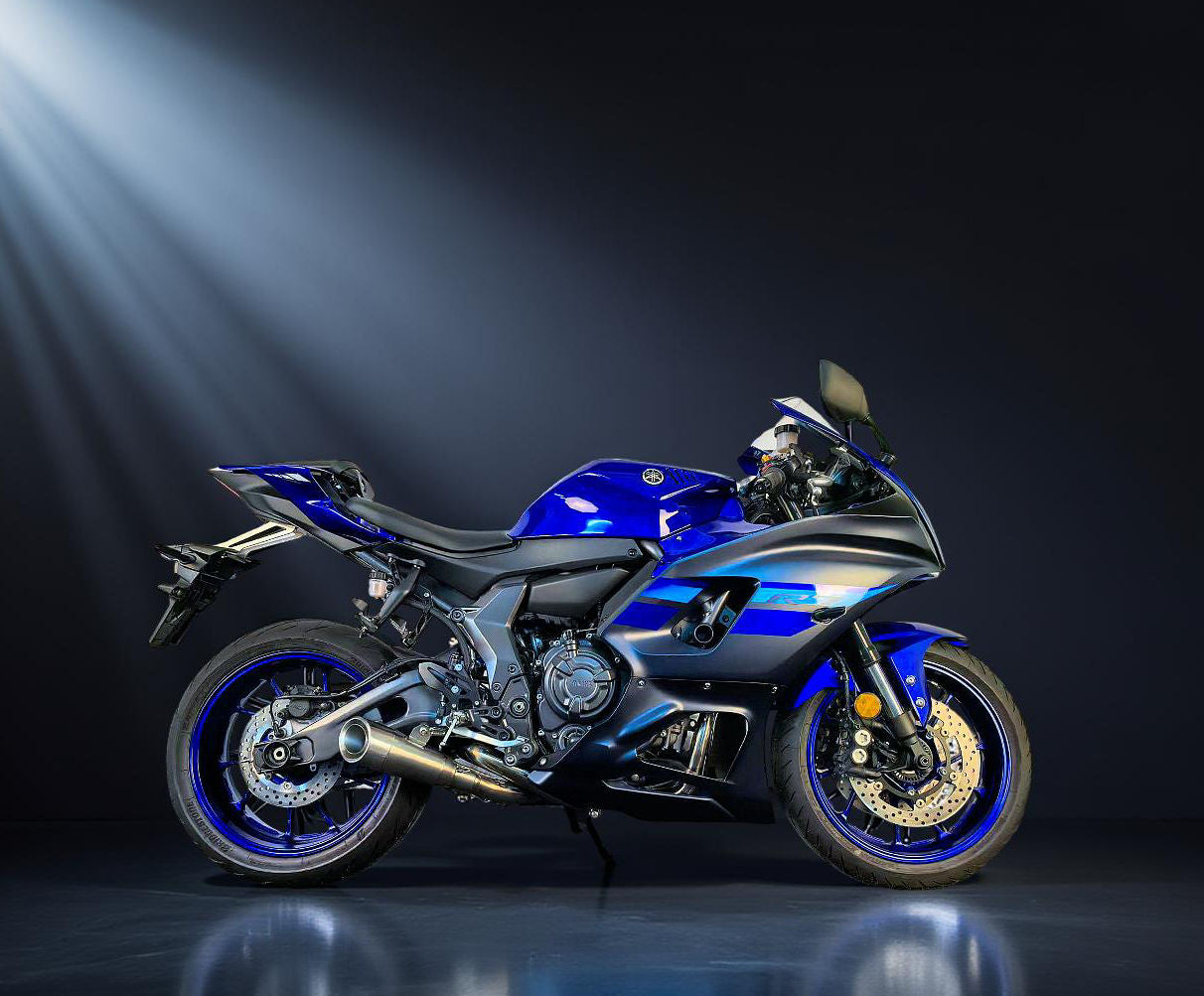 Blue BMW motorcycle on a dark background with spotlight effect
