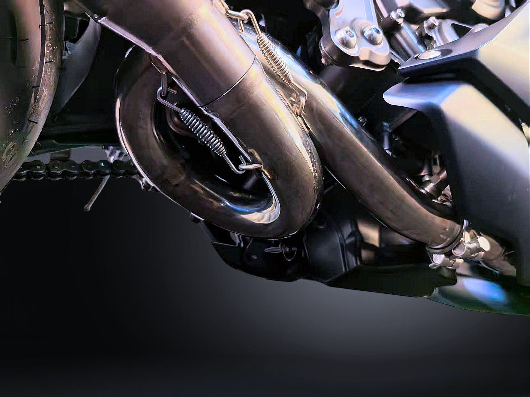 Close-up of a motorcycle exhaust system with a dark background
