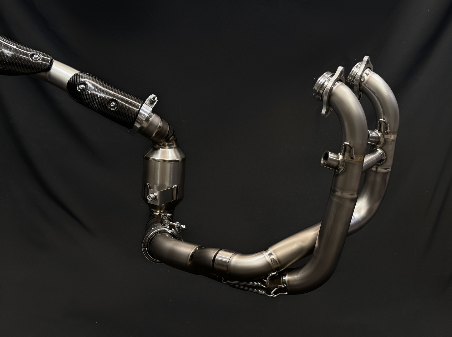 Metal exhaust pipe system on a black background