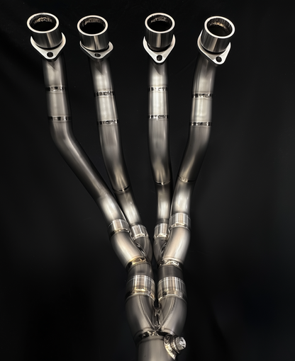 Set of metallic exhaust pipes on a black background