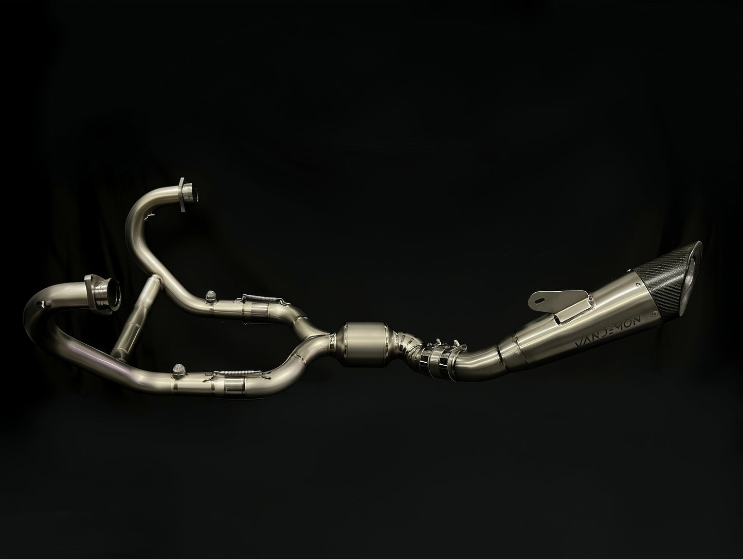 Metallic Vandemon exhaust pipe on a black background