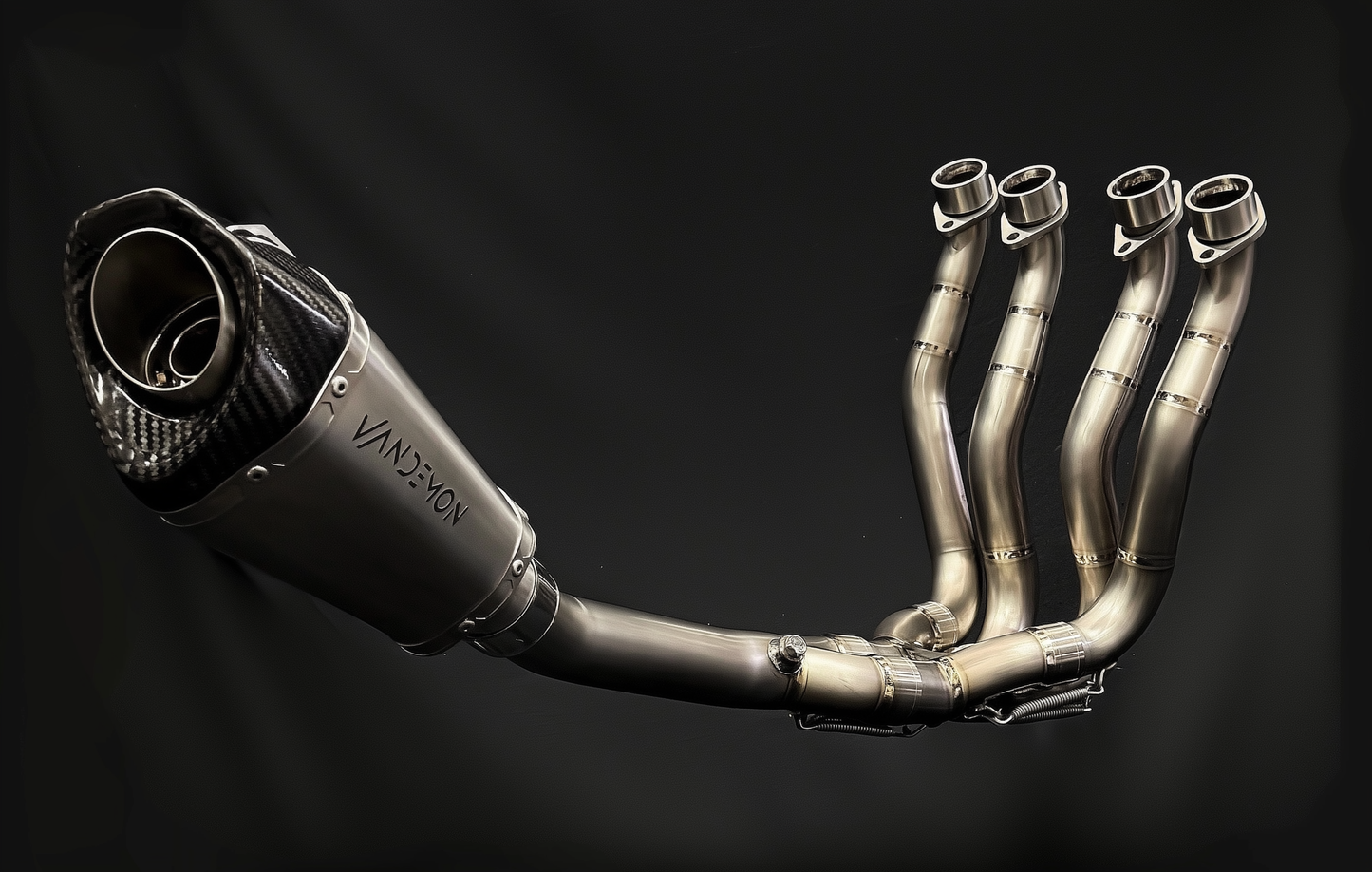 Metallic Vandemon exhaust system on a black background
