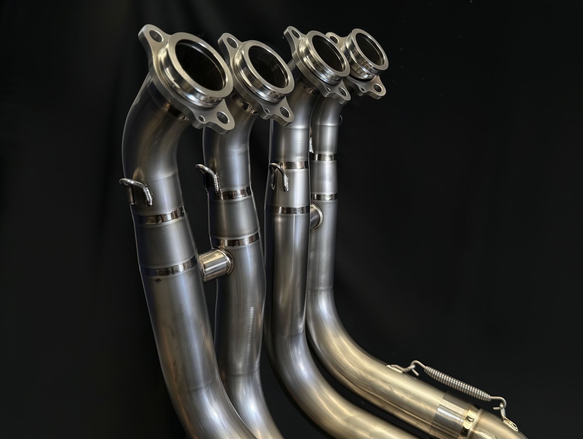 Metal exhaust pipes on a black background