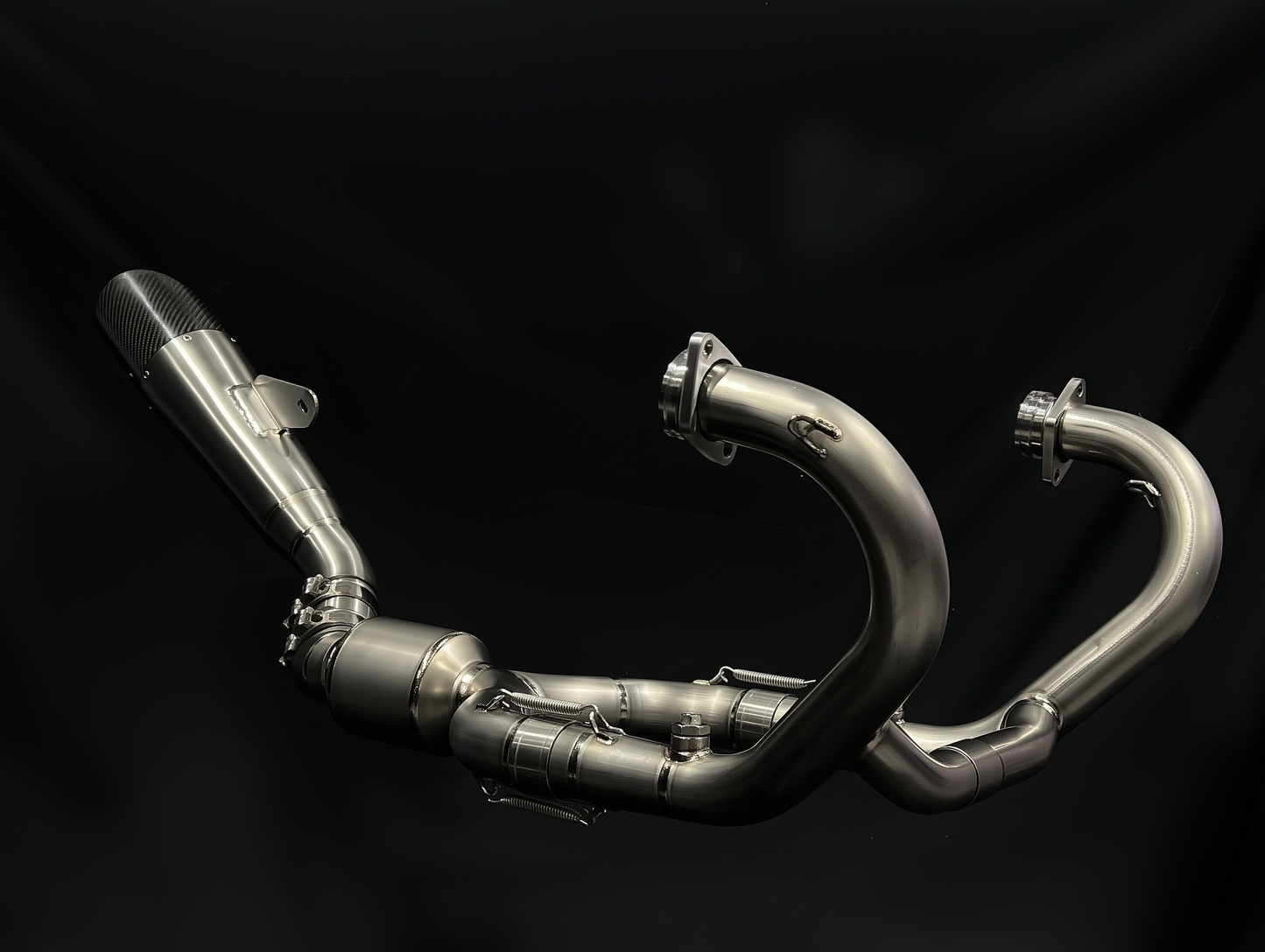 Metal exhaust pipes on a black background